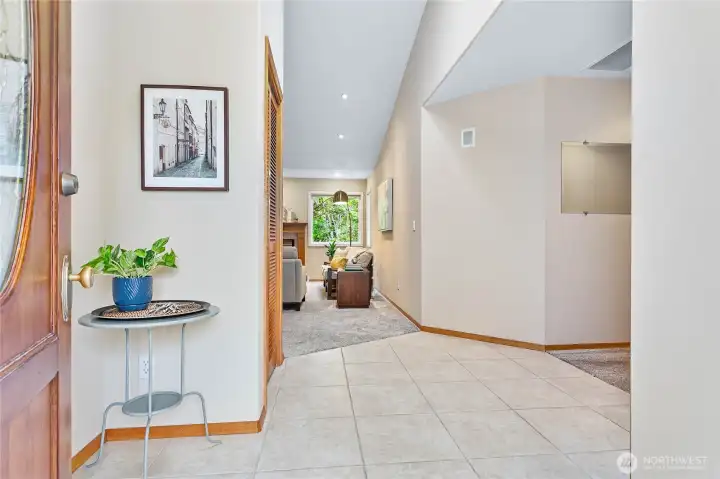 Welcoming entryway with vaulted ceilings and skylight.