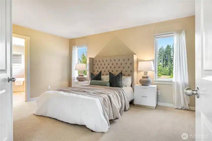 Spacious primary suite with serene greenbelt views.