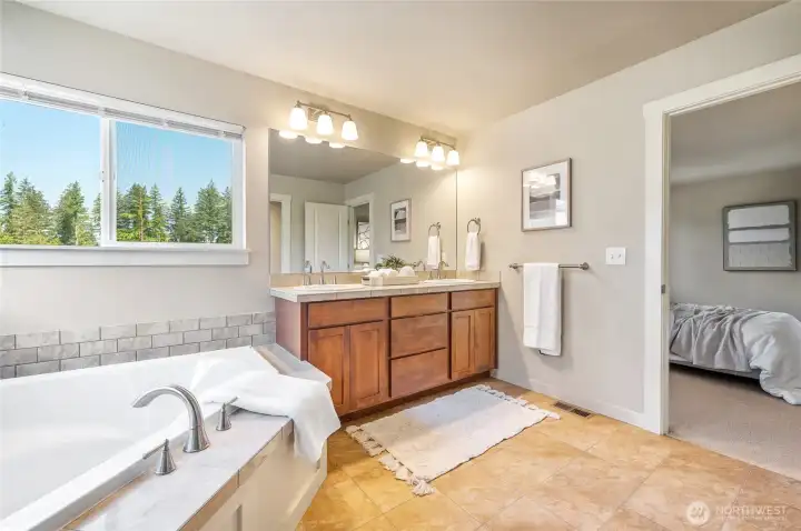 Soaking tub with tile surround in the primary bath..