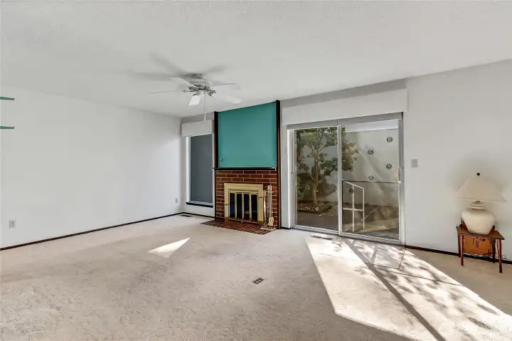 Living room w/cozy fireplace & slider to private patio