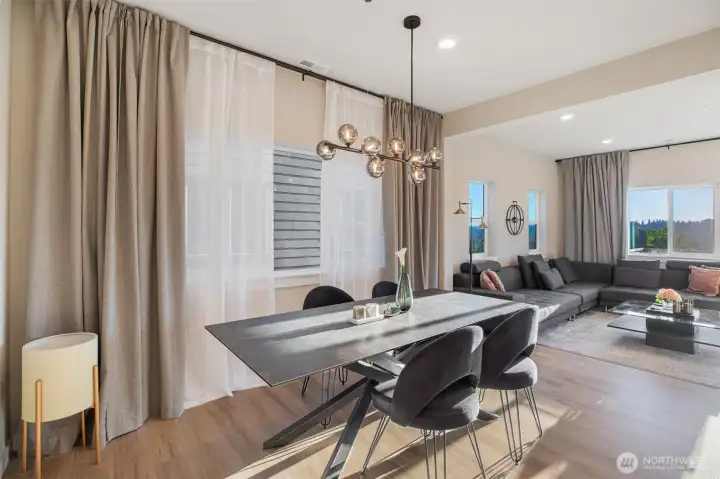 Large dining space with windows and custom dual drapery.