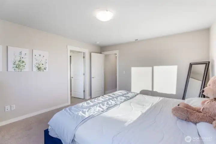 Primary bedroom is bright and spacious with walk-in closet.