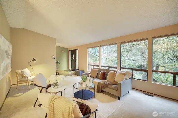 Expansive living room with large windows to front yard.