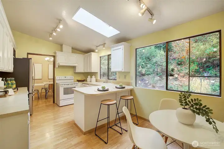 Roomy kitchen has eating area plus a bar.