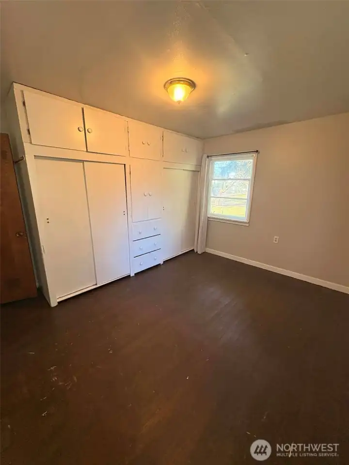 Bedroom number one has a large bank of built-ins.