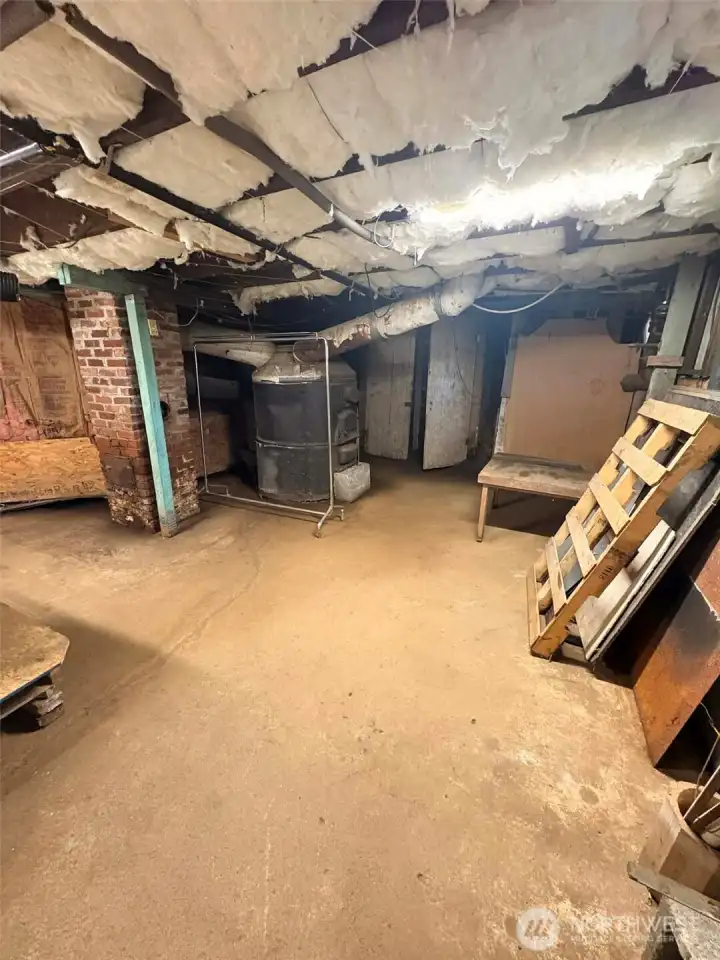 Coal/wood furnace is old and no longer working- get rid of that behemoth and you have even more space to play with ideas.