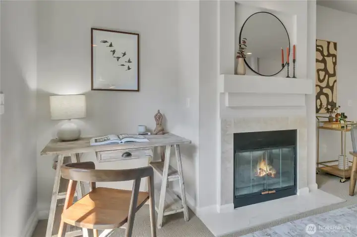 Living room features a cozy gas fireplace and a nook that fits a desk, perfect for a functional workspace.