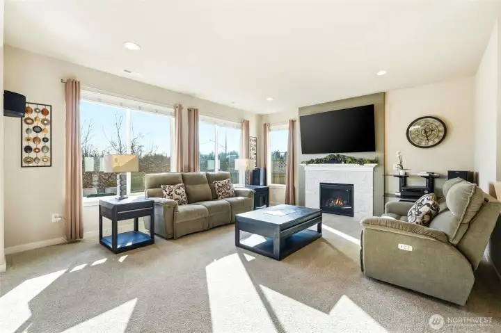 Next, flow into the open, light filled living room with southern facing windows, fireplace, and plenty of room for hanging out.