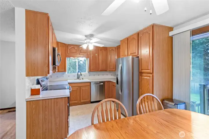 Kitchen w/ abundant oak cabinetry, stainless appliances & window overlooking the yard.