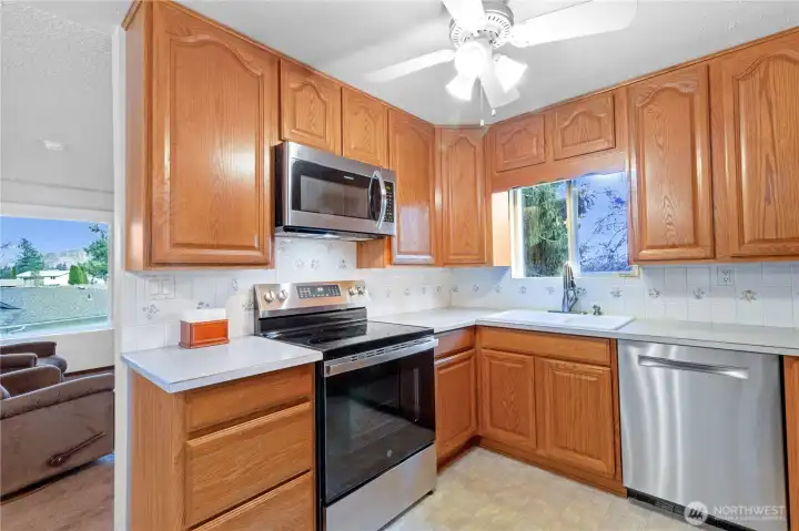 Efficient kitchen layout w/ ample cabinet storage & counter space.