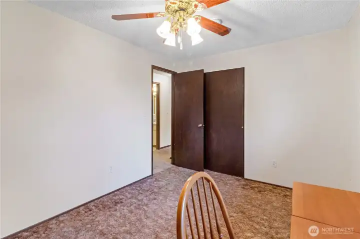 Another view of third upstairs bedroom highlighting closet storage.