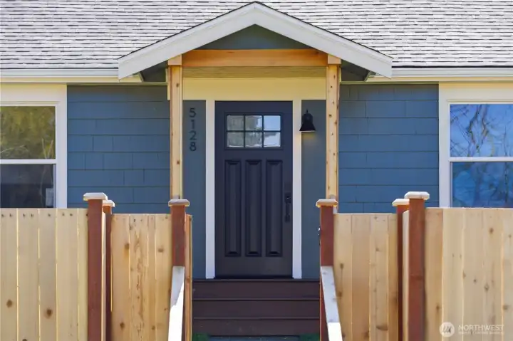 Front entry with covered porch and fenced yard