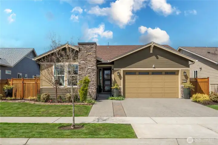 Statuesque street appeal welcomes you. With impressive stacked stone, beautiful landscaping, extra wide driveway and views of Mt. Rainier!