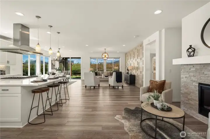 You will be immediately impressed when entering this home. Expansive hard surface flooring, custom lighting, stacked stone fireplace, a stunning feature wall (pre-wired for TV) and VIEWS!