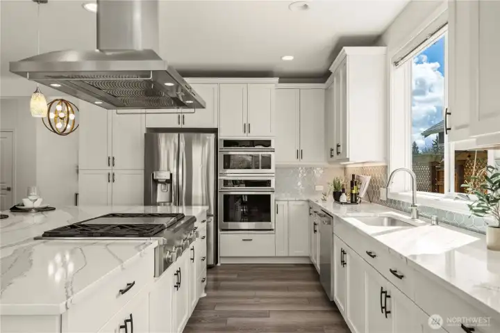 This stylish and timeless chef's kitchen offers Quartz counters, 42' cabinets w/ crown, gorgeous glass backsplash, designer hardware & extensive Shelf Genie storage systems.  The upgraded Monogram appliances include microwave w/ convection, toasts, broils & proofs. Oven with air fryer and stove with a griddle.