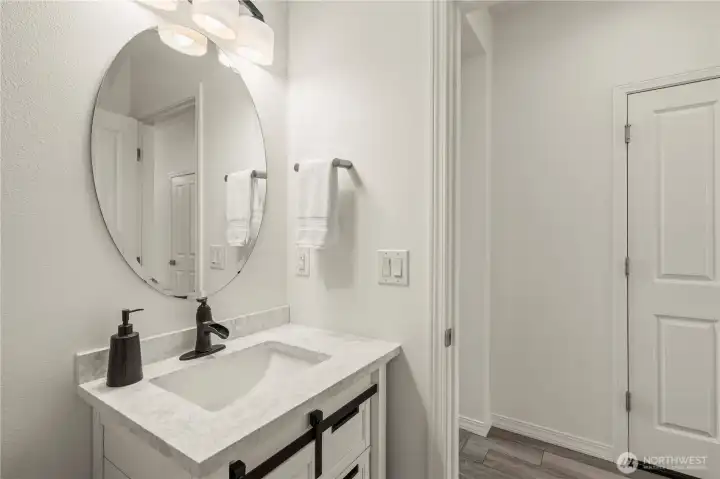 Beautiful custom powder room with designer cabinet.