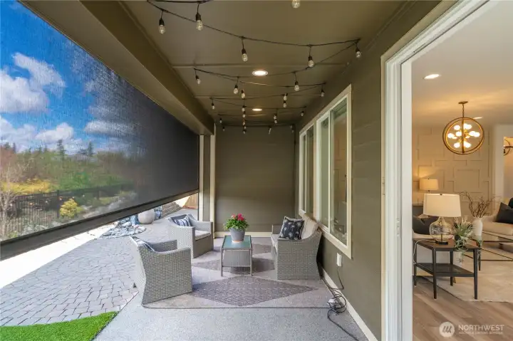 The large slider opens up to the covered patio overlooking this beautiful permanent green space. You will appreciate the motorized sunshade on warm afternoons or year around while still enjoying the view!