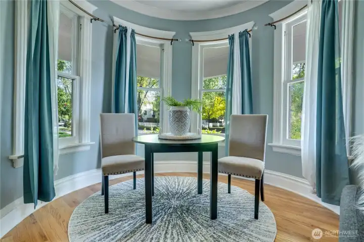 The rounded bay window nook in the front living room is a defining architectural feature of the home and one of the best spots to sit and relax.