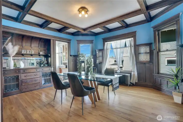 The main floor apartment's dining room is a case study in turn-of-the-century millwork. Note the distinctive built-in hutch with its curved top, the box beams, paneling, and plate rail trim.