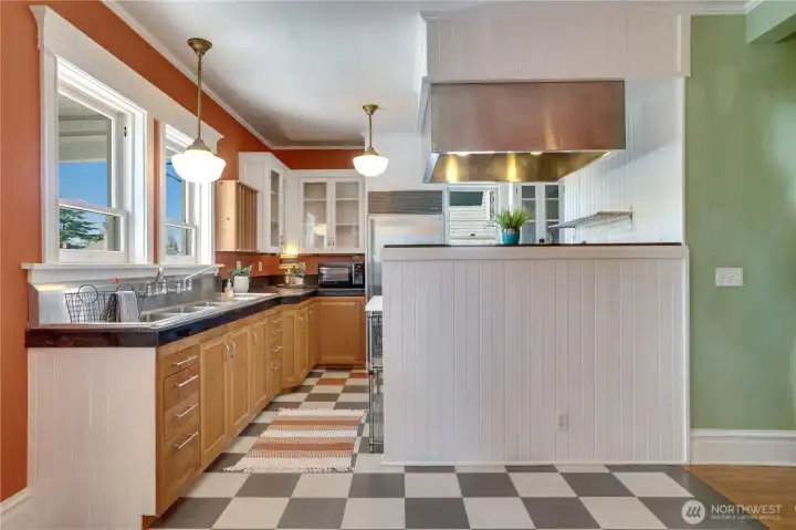 A kitchen full of character and light sits at the back of the house overlooking the deck.