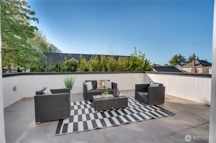 Set up an outdoor dining table and comfortable chairs for reading, lounging, and hosting. Along with this deck, there's garden space in the yard below, and you'll even see some raised beds out in the planting strip along the sidewalk.