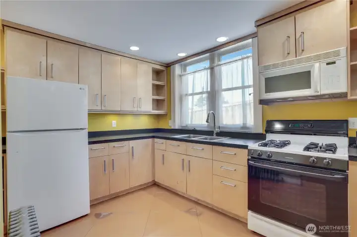 The studio includes a full kitchen with eco-friendly Richlite countertops and a gas range.
