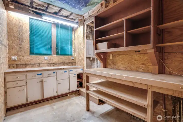 The basement offers a variety of storage spaces and work surfaces.