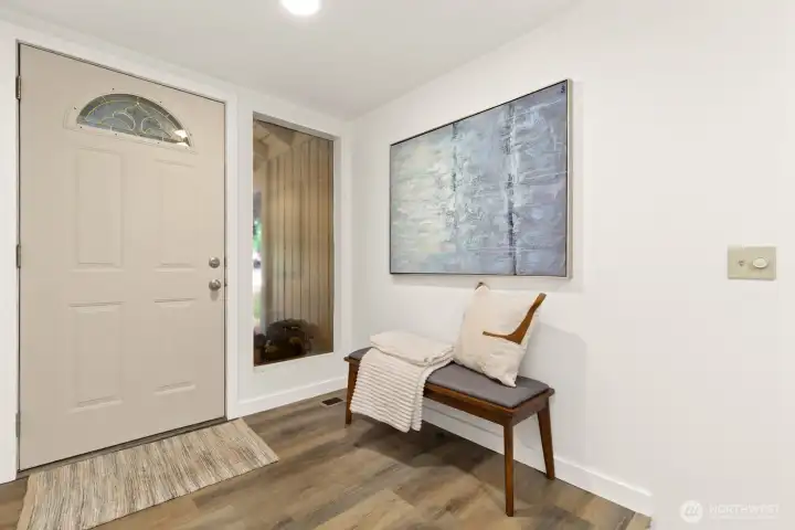 Entry way has a seating area and a coat closet just to the left in this photo.