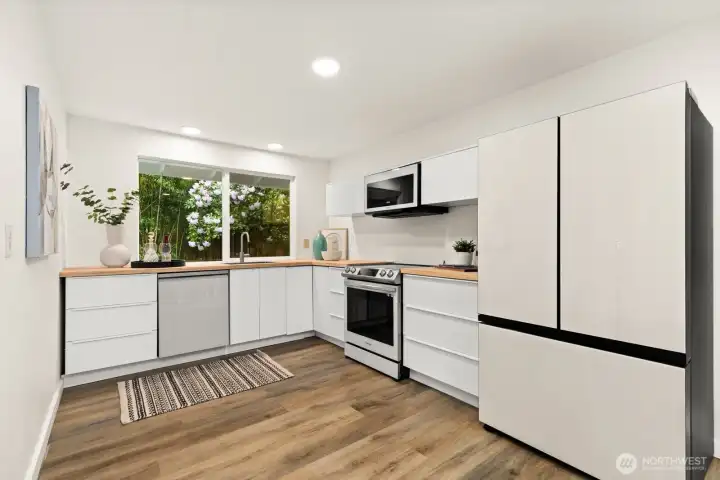 The remodeled kitchen is extremely functional - and has the window overlooking the backyard just behind the sink. Perfect spot!