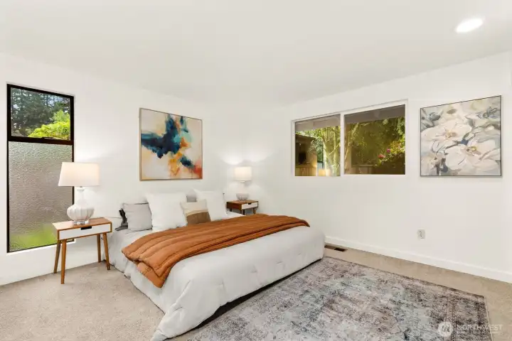 Down the hall is the primary ensuite bedroom. Lots of space here - this is a king-sized bed!
