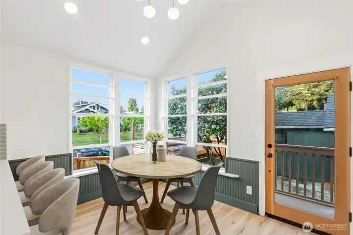 Kitchen bar and eating nook next to back patio door. Kitchen bar and eating nook next to back patio door.