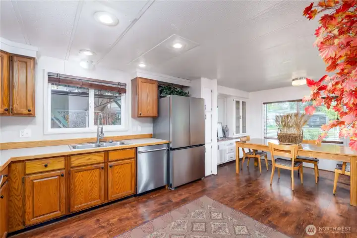 The adjoining dining area is filled with natural light and offers ample room for holiday dinners, casual breakfasts, and everything in between. With its exceptional storage, durable finishes, and open flow, this space is designed to make daily living easier and entertaining more enjoyable.