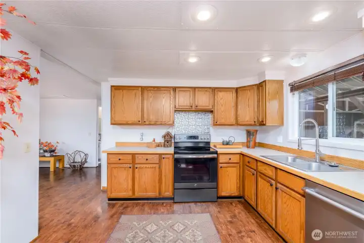 The heart of the home, this inviting kitchen and dining area blends warmth, functionality, and everyday comfort. Rich oak cabinetry provides an abundance of storage for cookware, small appliances, pantry items, and all the essentials, while built-in dining room cabinetry offers even more space for serving pieces, linens, and entertaining supplies.