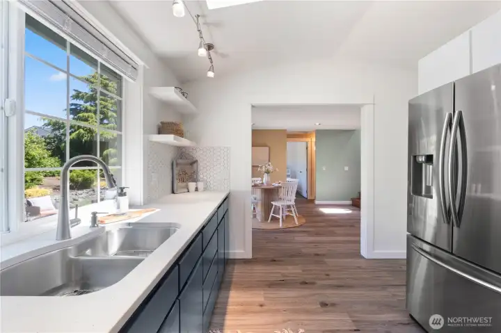 Kitchen facing dining area.  Large window facing backyard