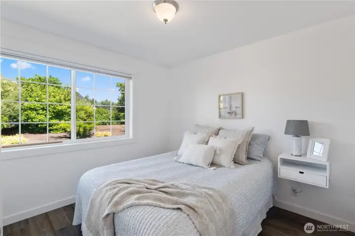 2nd downstairs bedroom with view of the backyard