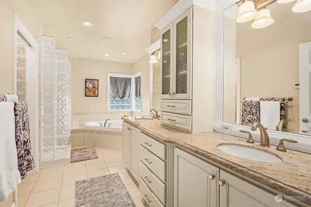 Luxurious primary bath with a dual sink vanity, soaking tub, and separate shower.