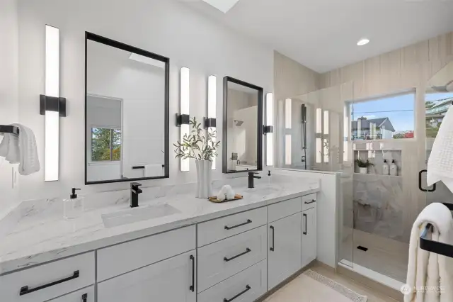 Fabulous primary bath features heated tile floors, oversized fully tiled shower with 2 showers heads, custom glass shower doors, matt black fixtures, double sinks, quartz counters, seperate water closet and skylight.