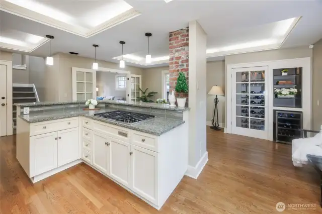 Chef's kitchen with a custom wine cabinet & wine fridge.