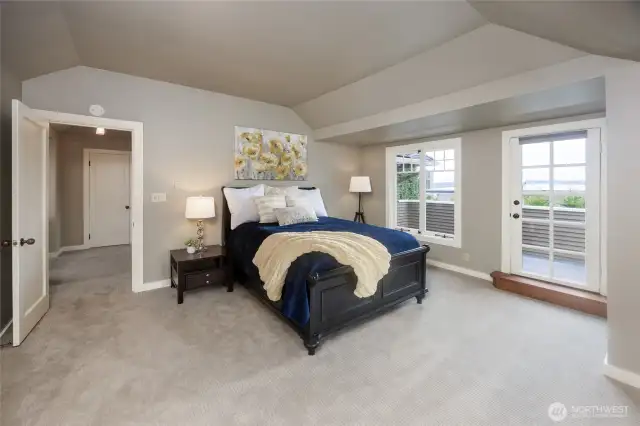 Luxurious primary suite offers a balcony with lake views.