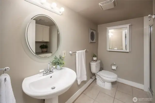 Lower level 3/4 bathroom offers cabinet space on other side of the room.