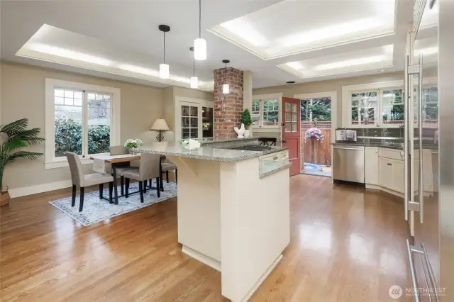 Updated kitchen offers breakfast dining, custom wine cabinet & fridge, Sub-Zero, Bosch double-oven & Dutch door access to the private deck & hot tub.