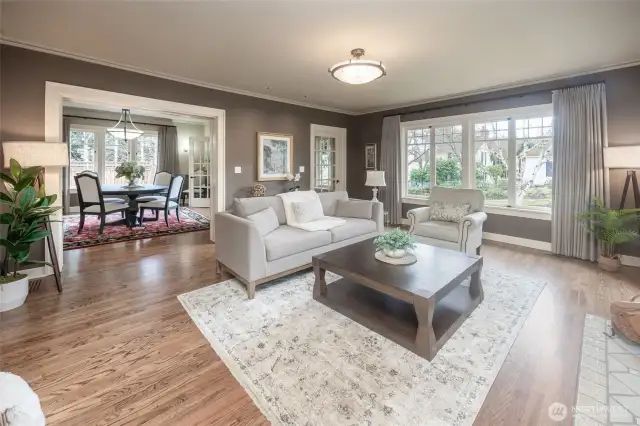 Spacious formal living & dining rooms featuring refinished hardwood floors, abundant windows & a gas fireplace.