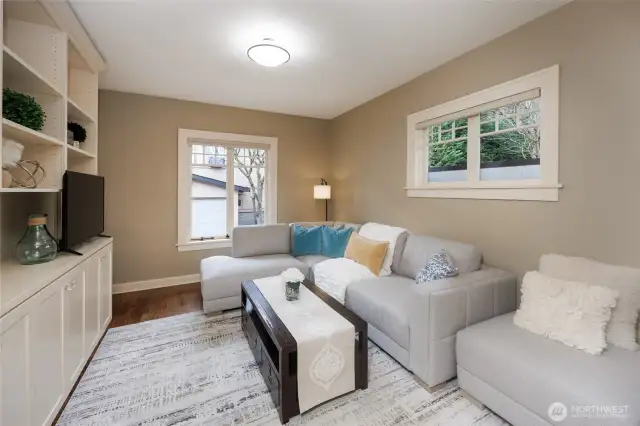 Main floor office/family room/guest bedroom featuring French doors & custom cabinetry.