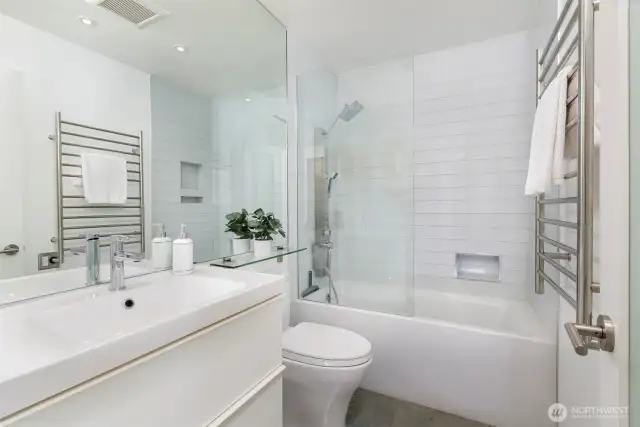 The stunning bathroom has radiant floor heat, a heated towel rack and custom finishes