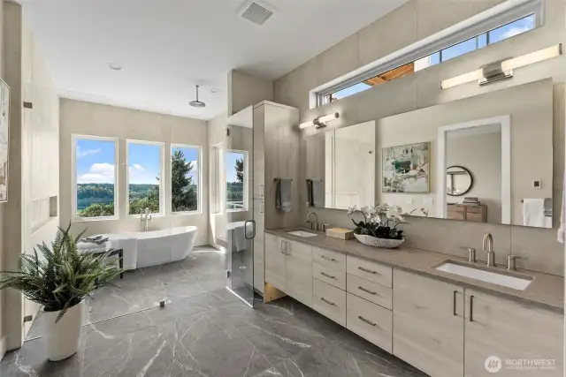 This grand primary suite bathroom is a true showstopper—featuring a luxurious wet-room style shower with a rain showerhead, heated floors, and striking design details that elevate everyday living.