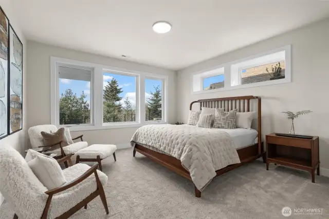 Another angle of the guest suite highlights its spacious layout, complete with an attached bathroom and a full-sized closet for ultimate convenience and comfort.