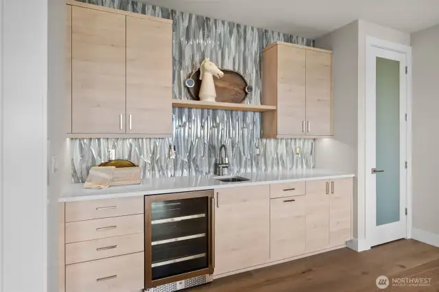 Entertaining is a breeze with a convenient sink and beverage fridge downstairs, complemented by additional Bellmont cabinetry for both style and storage.