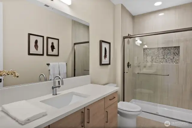 The attached bathroom to the second guest suite is designed for both style and functionality, offering a private and serene space for guests to enjoy.