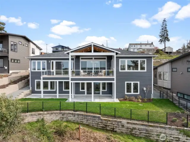 The back of the home is thoughtfully designed with covered living spaces both upstairs and downstairs. Fully fenced and equipped with full irrigation, the backyard is complete and ready for relaxation or entertaining.