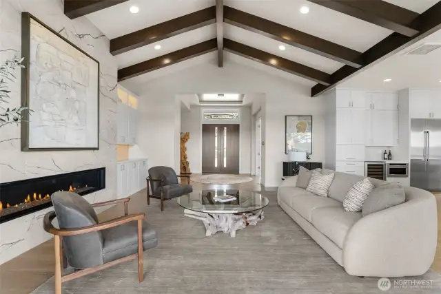 An expansive open-concept living and kitchen area, designed for seamless entertaining, offers the perfect space for gathering with friends and family while enjoying breathtaking views.
